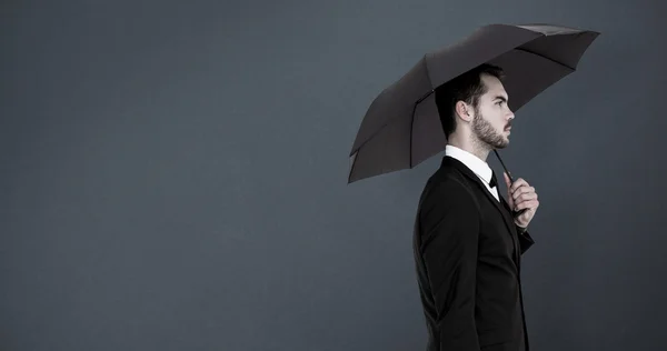 Businessman under umbrella — Stock Photo, Image