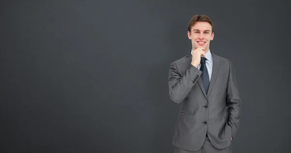 Thinking businessman against grey — Stock Photo, Image