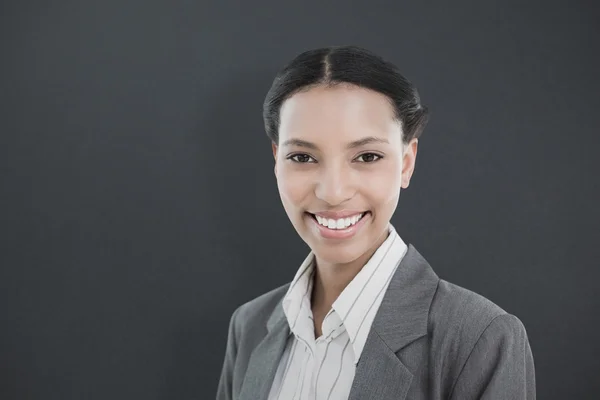 Businesswoman against grey — Stock Photo, Image