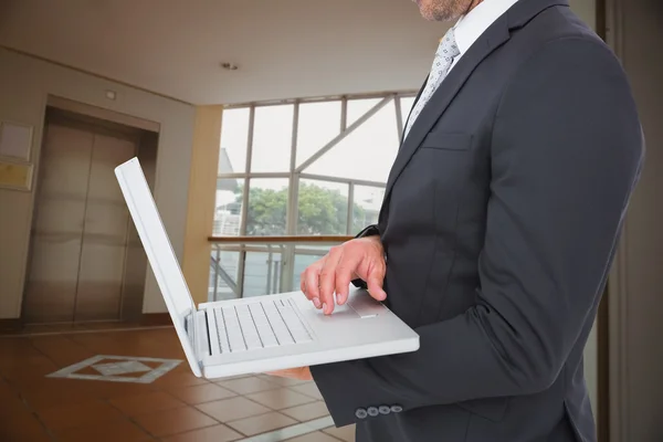 Businessman holding laptop — Stock Photo, Image