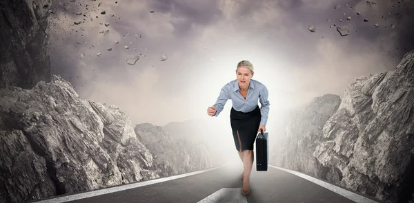 Businesswoman running and holding briefcase — Stock Photo, Image