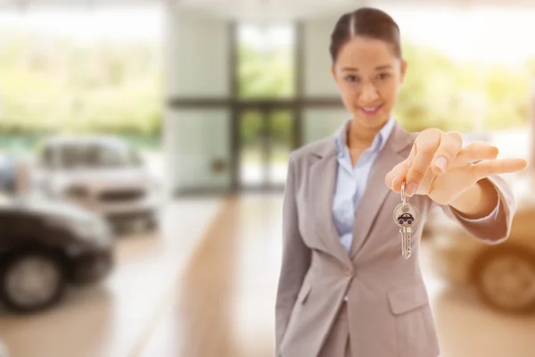 Composite image of portrait of a smiling businesswoman holding a — Stock Photo, Image