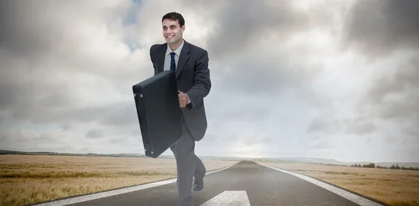 Smiling businessman in a hurry — Stock Photo, Image