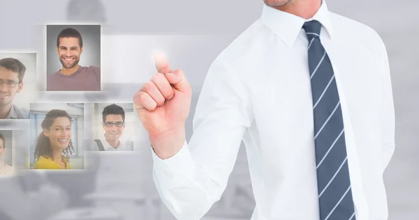 Composite image of businessman pointing with his finger — Stock Photo, Image