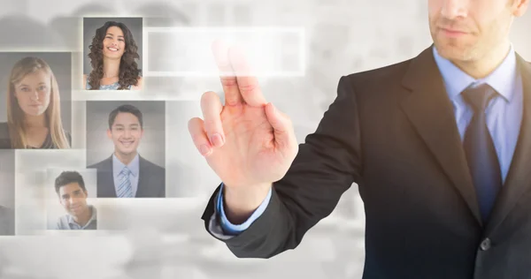 Composite image of businessman pointing these fingers at camera — Stock Photo, Image
