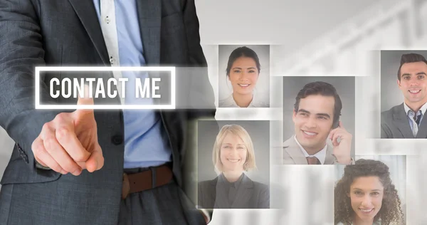 Composite image of businessman in grey suit pointing — Stock Photo, Image