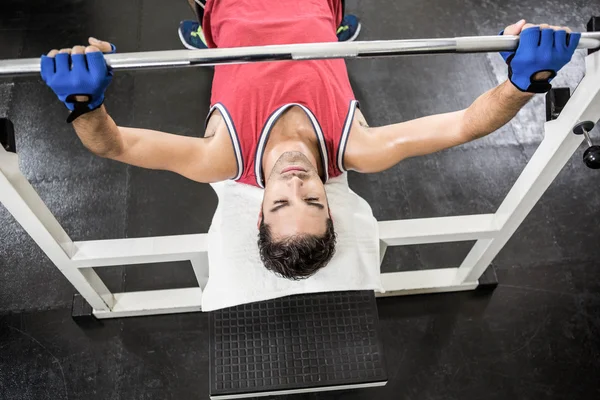 Uomo muscolare sollevamento bilanciere su panca — Foto Stock