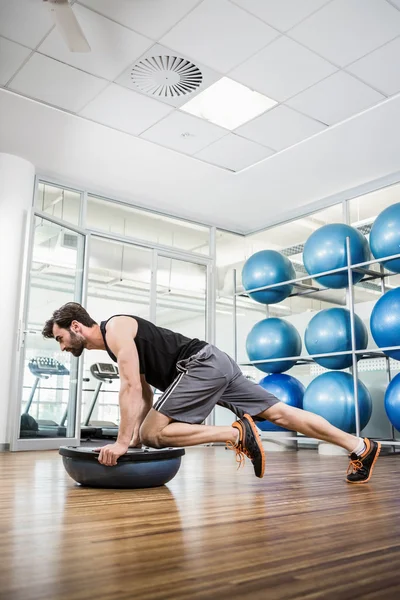 Hombre serio haciendo ejercicio con Bosu Ball — Foto de Stock