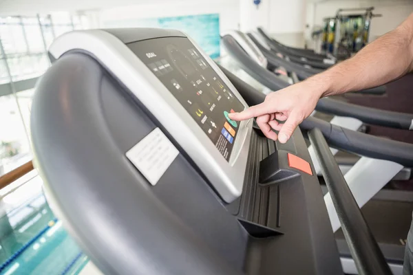 Man hand setting treadmill — стоковое фото