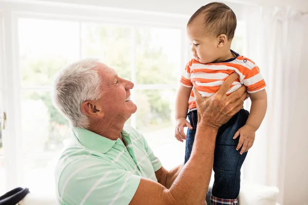 Senior man playing with his grandson — Stock Photo, Image