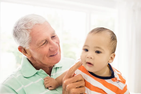 Senior man playing with his grandson — Stock Photo, Image