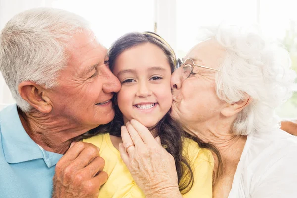 Grandparents kissing their granddaughter — Stock Photo, Image