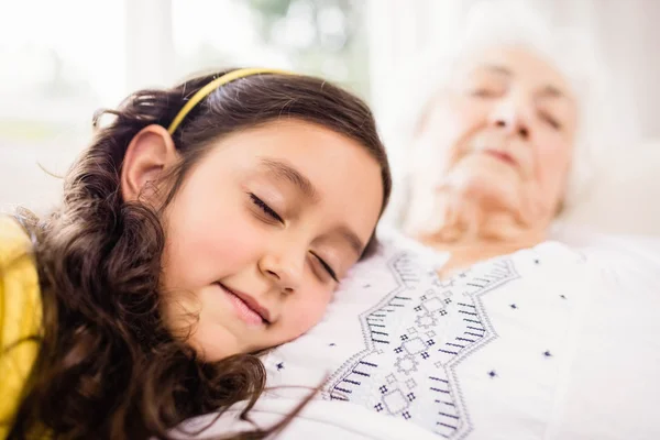 Relaxed granddaughter and grandmother napping — Stock Photo, Image