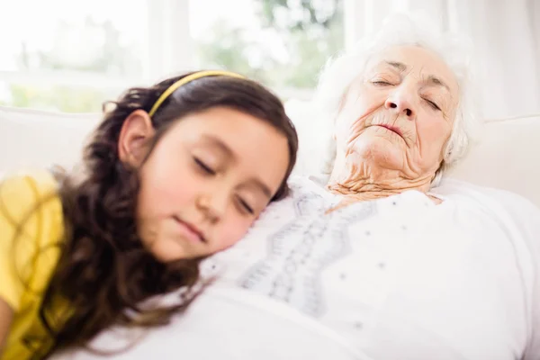 Relaxed granddaughter and grandmother napping — Stock Photo, Image