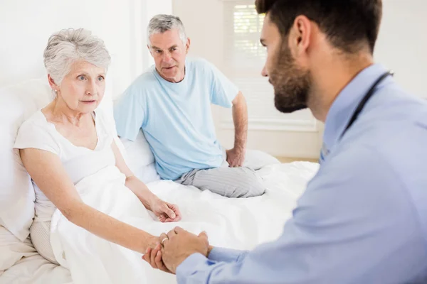 Handsome nurse holding hand of mature woman — Stock Photo, Image