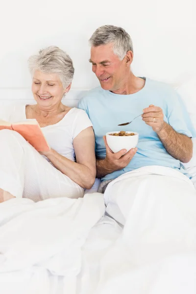 Happy senior couple at bed — Stock Photo, Image