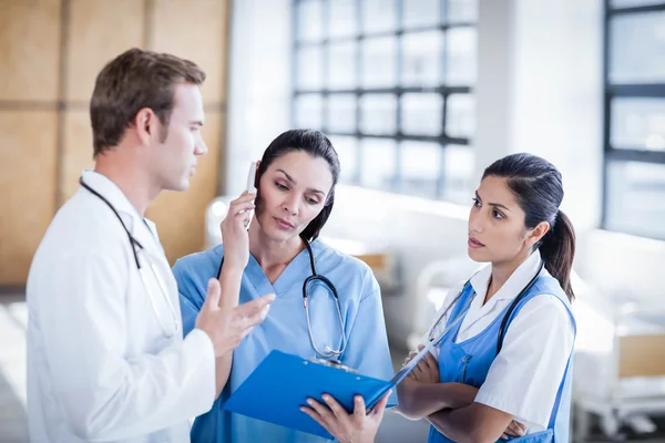 Equipo médico discutiendo el informe juntos — Foto de Stock