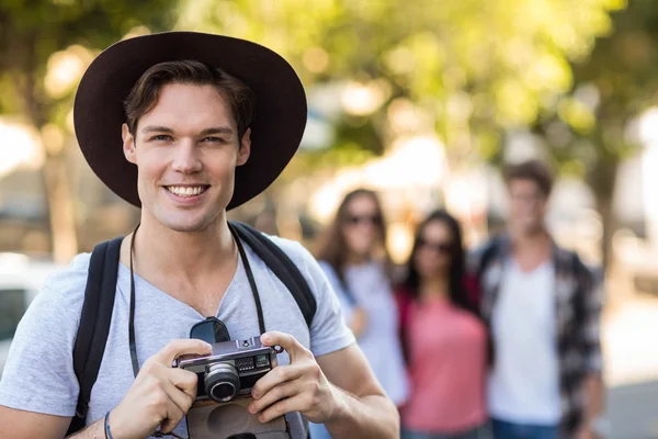 Hip man holding digital camera — Stock Photo, Image