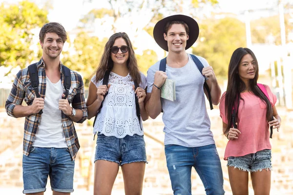 Hip friends walking and holding a map — Stock Photo, Image