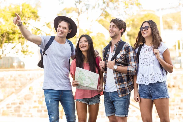 Amigos de la cadera que van a caminar y comprobar el mapa —  Fotos de Stock