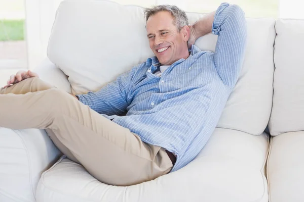 Hombre feliz relajándose en el sofá — Foto de Stock