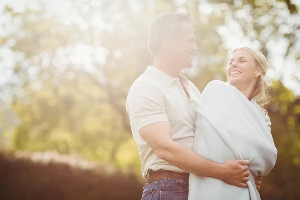 Mann umarmt seine Frau in einer Decke — Stockfoto