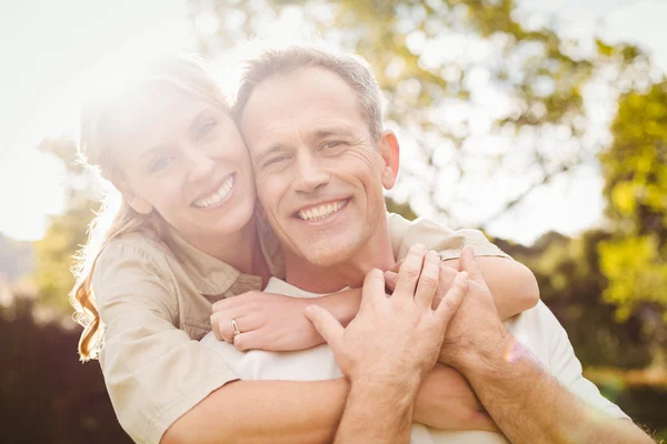 Cute couple with arms around each other — Stock Photo, Image