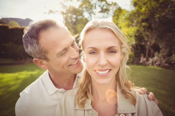 Husband whispering something to wifes ears — Stock Photo, Image