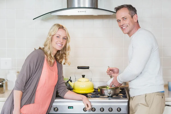 Cute couple using copper kettle — Stock Photo, Image