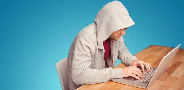 Businessman with hooded shirt working on laptop — Stock Photo, Image