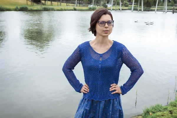 Portrait of young woman in blue clothes against a dutch canal — Stock Photo, Image