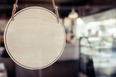 Modern kafe restoranında güneş ışığı olan cam kapıya boş ahşap pano, metin reklamları için fotokopi alanı, kafe restoranı, reklam pazarlama ve küçük işletme sahibi kavramı
