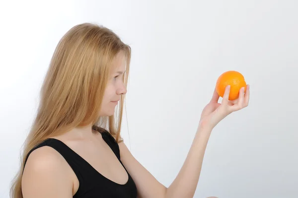 Girl with orange in her hands — Stock Photo, Image