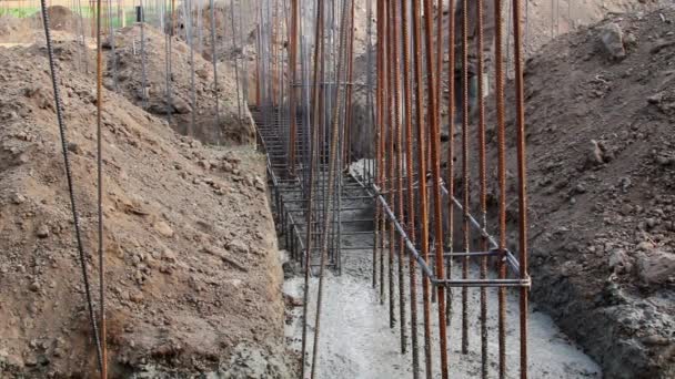 Worker pouring cement and concrete with pump tube into formwork reinforcement — Stock Video