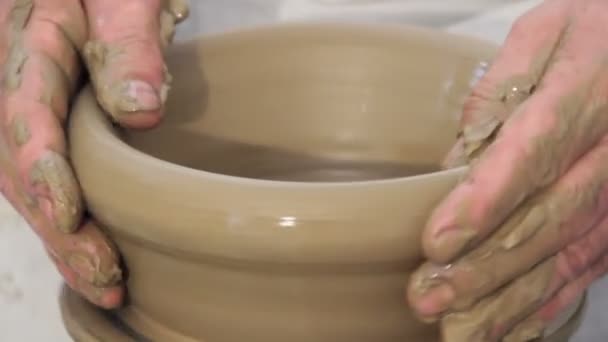 Hands shaping on a potter's kick wheel — Stock Video