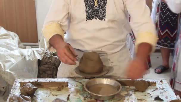 Craftsman shapes pottery on an classic potter's kick wheel — Stock Video