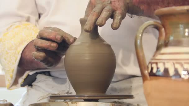 Craftsman shapes pottery on an classic potter's kick wheel — Stock Video