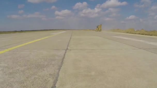 Heavy construction equipment working on an airport runway, aerial view — Stock Video