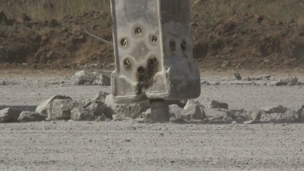 Hydraulic crushing hammer breaking concrete on an airport runway — Stock Video