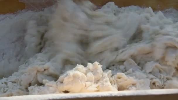 Man kneading dough in a wooden bowl — Stock Video