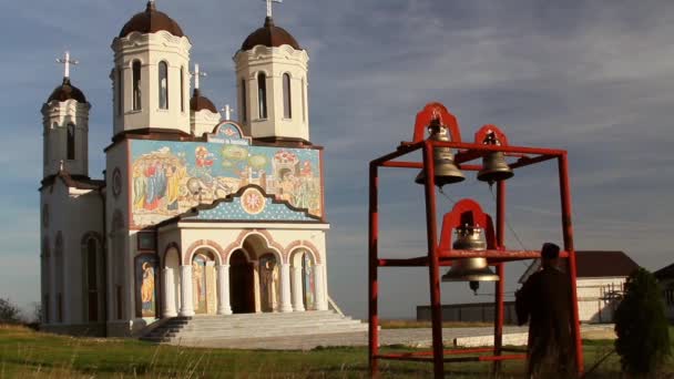 Monje cristiano tocando campanas en el monasterio santo de Codru en Dobrogea, Rumania — Vídeo de stock