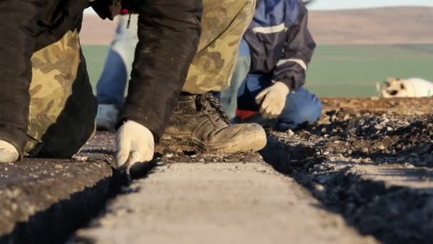 Los trabajadores cavan trincheras para tender cables para el sistema de iluminación del aeródromo — Vídeo de stock