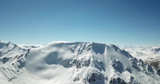 Vliegen over de toppen van besneeuwde bergen . — Stockvideo