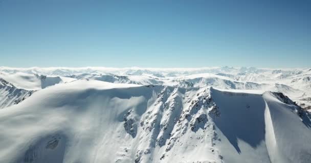 Vliegen over de toppen van besneeuwde bergen . — Stockvideo