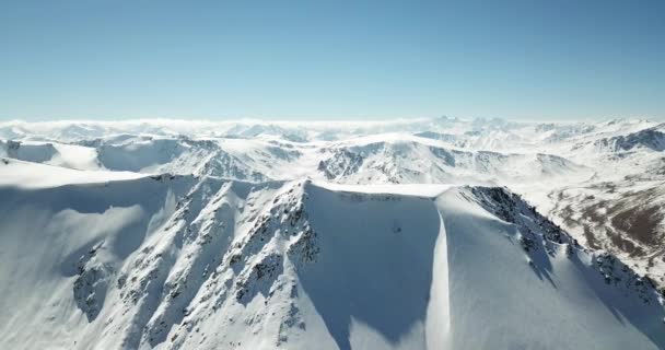 Vliegen over de toppen van besneeuwde bergen . — Stockvideo