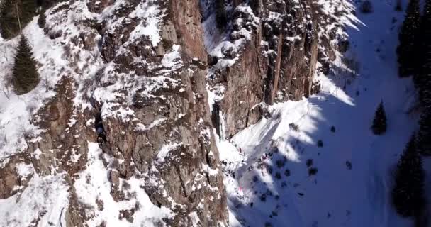 Eiskalter Wasserfall in den schneebedeckten Bergen. — Stockvideo