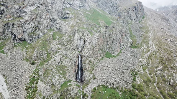 High waterfall among the rocks. View from a drone.