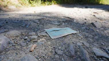 Tıbbi maske yerde yatıyor..