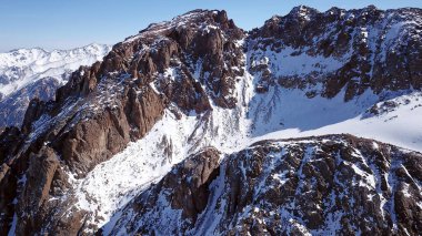High snow-capped peaks and glaciers from the top.