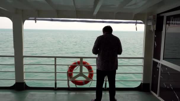 A man stands on the ferry. Travel by water. — Stok video